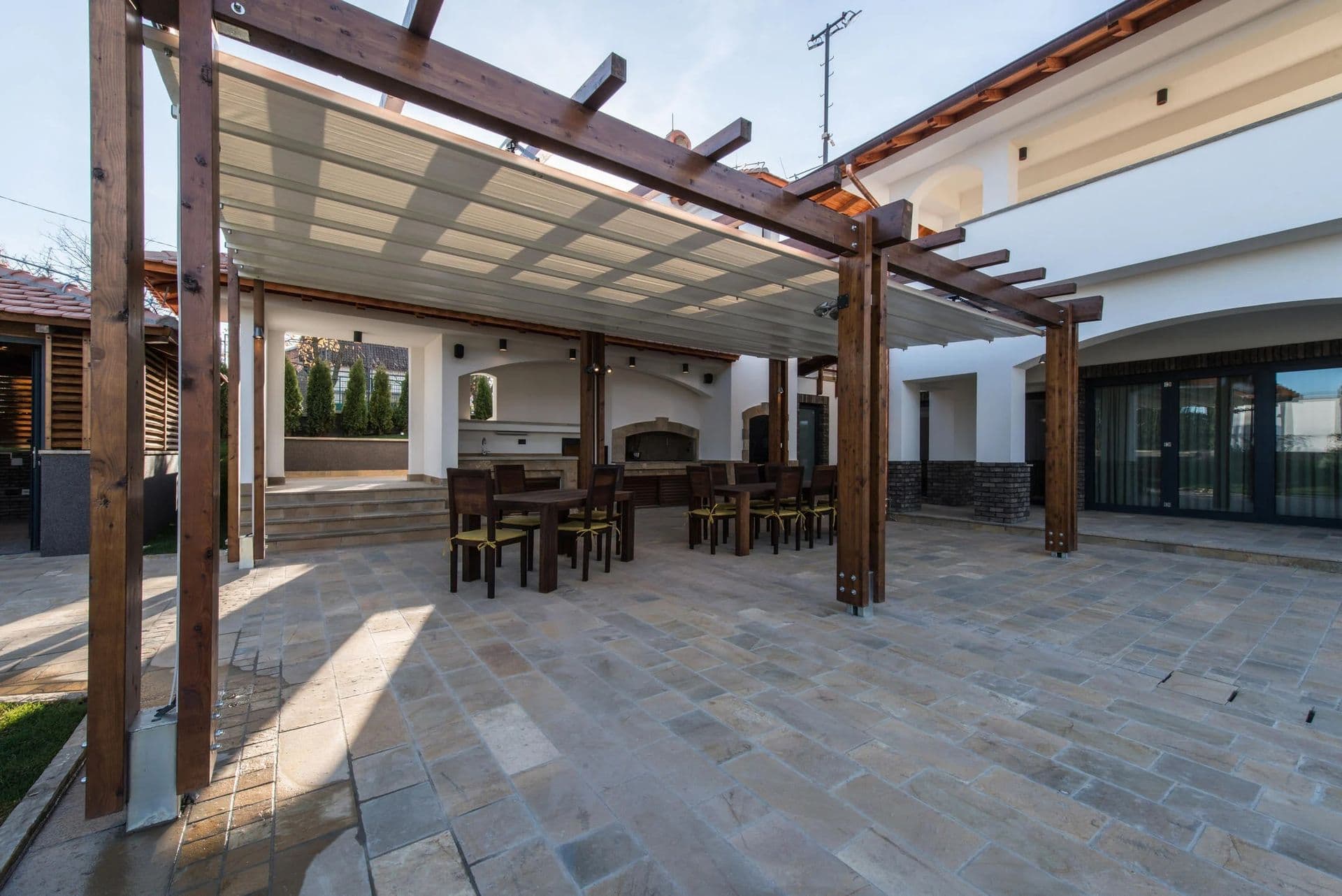 patio with wooden chairs and tables