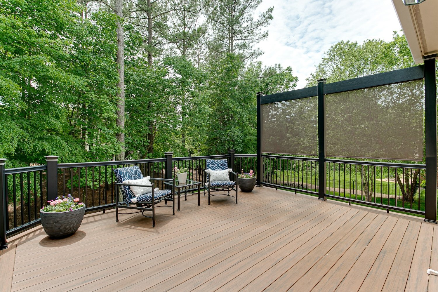 Beautiful Summer Staged Deck with Nature Woods and a Flower Pot and Privacy Screen