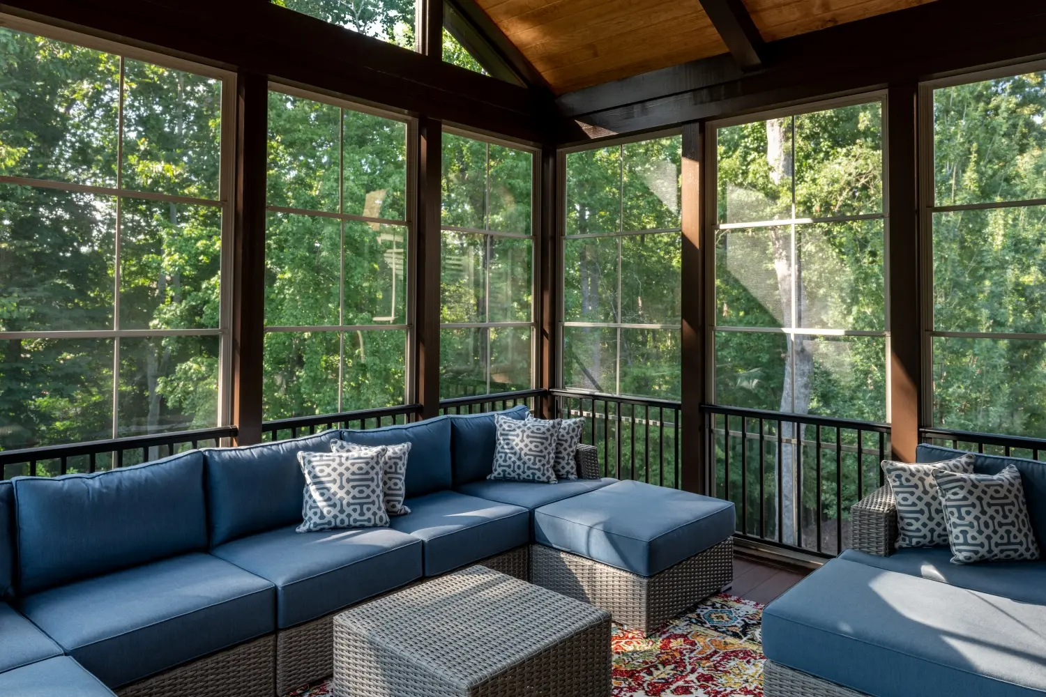 Screen patio enclosure attached to a home, providing a sheltered outdoor living space with patio furniture.