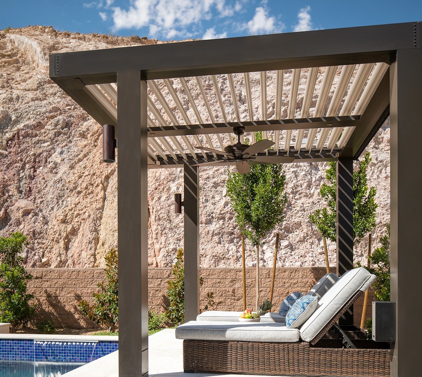 struxure pergola with lounging chairs near a pool